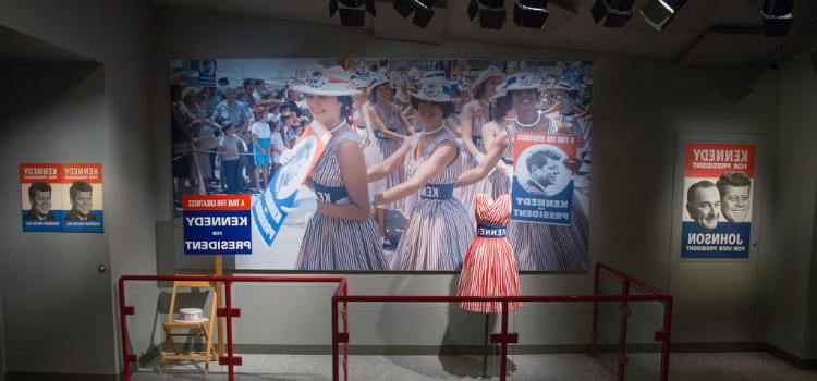 a display with a photo and one of jackie kennedy's dresses at the JFK presidential library and museum